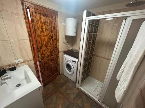 a bathroom with a sink and a washing machine at Malibu Ocean View in Adeje