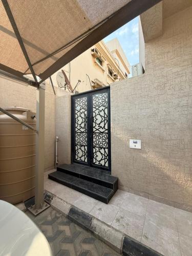 a door with a black gate in a building at ليالينا in Dammam
