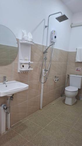 a bathroom with a shower and a toilet and a sink at DD Bangrak Hotel in Koh Samui