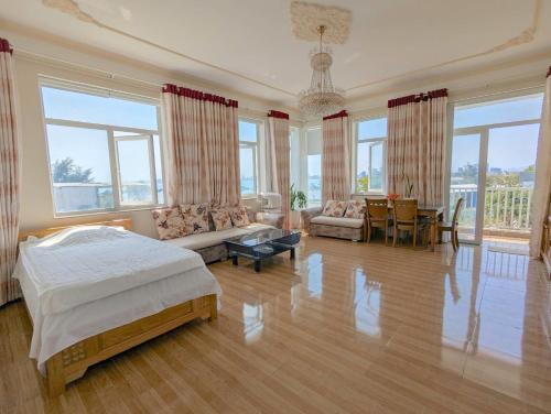 a large bedroom with a bed and a living room at AN Apartment in Danang