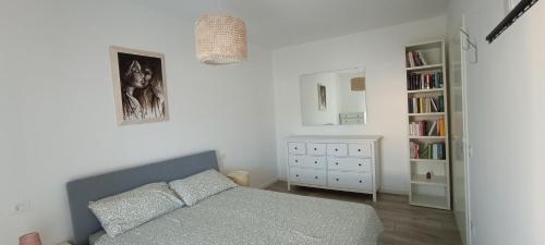 a bedroom with a bed and a book shelf at Casa Soria in Pesaro