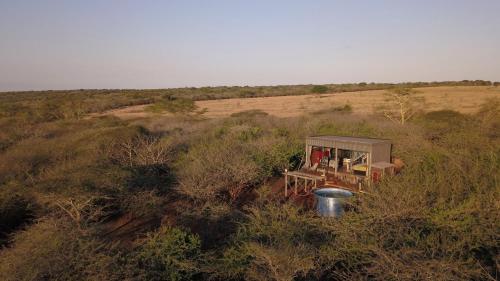 an aerial view of a house in the middle of a field at Mudhouse Zululand in Hluhluwe