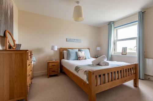 a bedroom with a large bed and a window at The View, 22 School Park in Kingsbarns