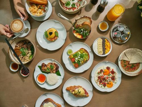 a table with many plates of food on it at Park Hyatt Bangkok in Bangkok