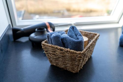 a basket of towels sitting on a table next to a window at Schössersmühle in Eisenberg