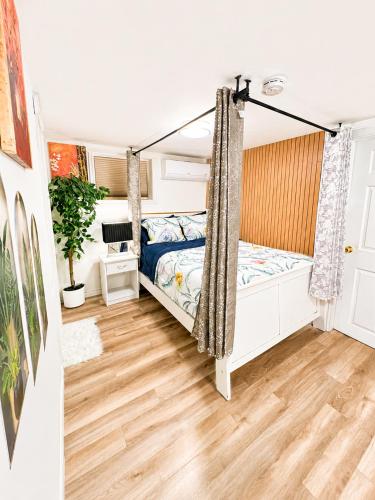 a bedroom with a bed and a swing at Cozy 2-Bedroom Suite Near Moncton Hospital & NBCC in Moncton