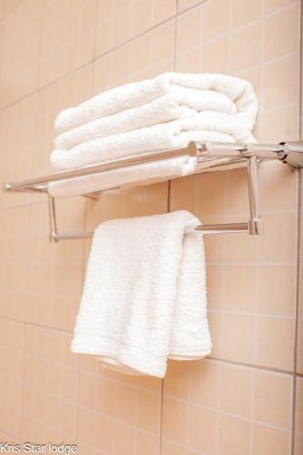 a group of towels on a towel rack in a bathroom at Kris Star Lodge in Blantyre