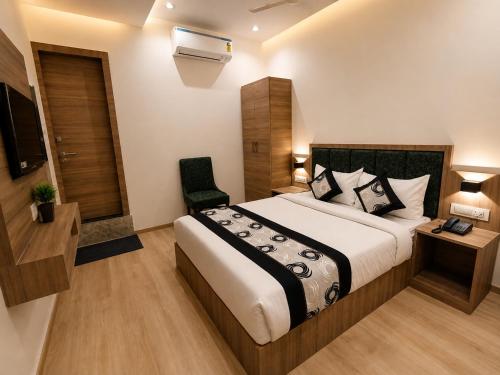a hotel room with a bed and a chair at Hotel Beverly Palace Santacruz - Near BKC - Mumbai Airport T1 in Mumbai