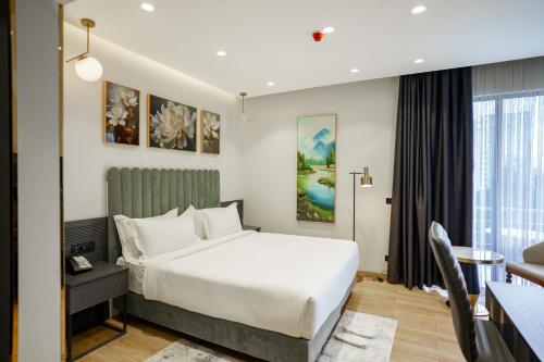 a hotel room with a bed and a desk at Vora Addis Hotel in Addis Ababa