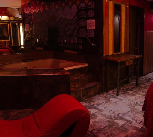 a bath room with a tub and a table at Bellas Artes Palace Secret Suites Adult Only in Santiago