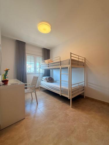 a room with two bunk beds and a desk at Villa Roja in Bigastro