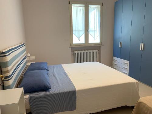 a bedroom with a large bed and a window at Maria Pia's home in Marotta