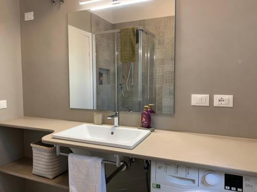 a bathroom with a sink and a shower at Maria Pia's home in Marotta