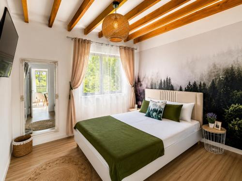 a bedroom with a bed and a window at Triovista Chalets in Nehoiu