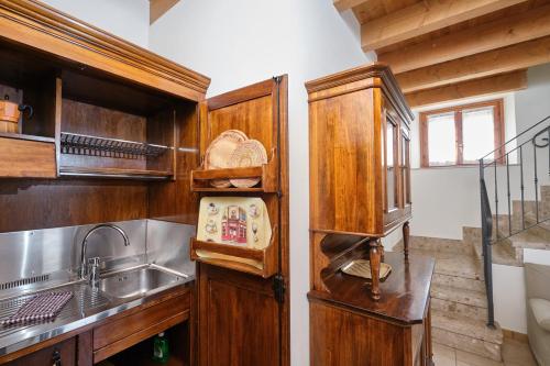 a kitchen with wooden cabinets and a sink at Agriturismo Della Pieve in Bardolino