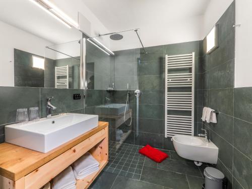 a bathroom with a sink and a toilet and a shower at Gasthof Zur Sonne in Laion