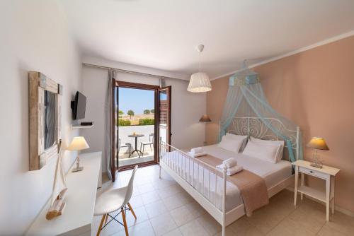 a bedroom with a bed and a balcony at Lindos Aeonian Villas in Lindos
