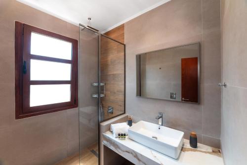 a bathroom with a sink and a shower at Lindos Aeonian Villas in Lindos