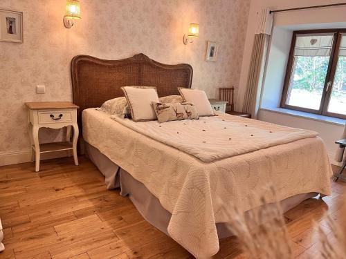 a bedroom with a large bed in a room at Le Clos du Cerf in Cellettes