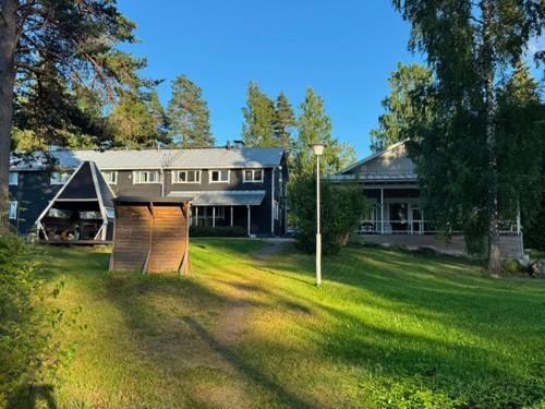 a large house with a large yard in front of it at Norppa Lake Resort in Savonlinna