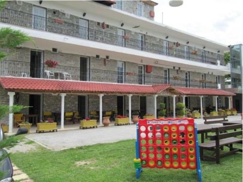 a building with a bunch of dominoes in front of it at Sun Studios Pieria in Paralía Skotínis