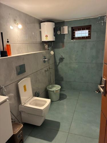 a bathroom with a toilet and a sink at Fiddlehead Fern in Kurchi