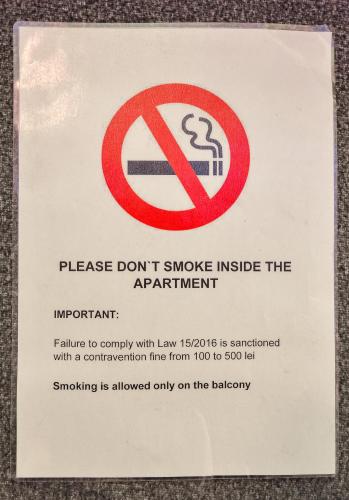 a sign that says dont smoke inside the apartment at Harmony Residence in Bucharest