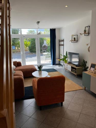 a living room with a couch and a table at The 8th in Léglise