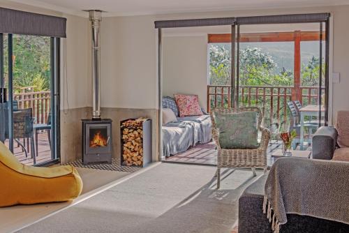 a living room with a couch and a fireplace at Mountainview Sedgefield in Sedgefield