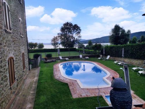 a person is looking at a swimming pool in a yard at Le Rondini in Torricella