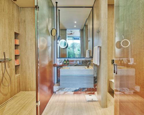 a bathroom with a shower and a sink and a tub at Voyage Kundu in Antalya