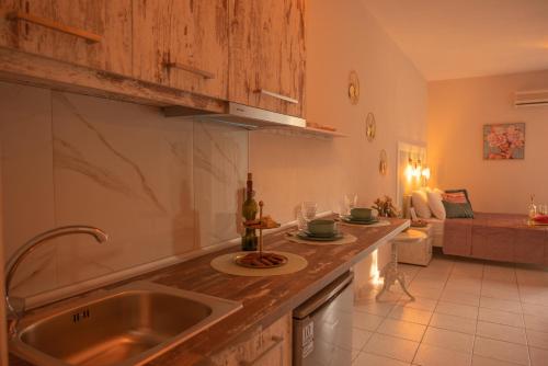 a kitchen with a sink and a living room with a couch at vranas hotel in Skala Sotiros