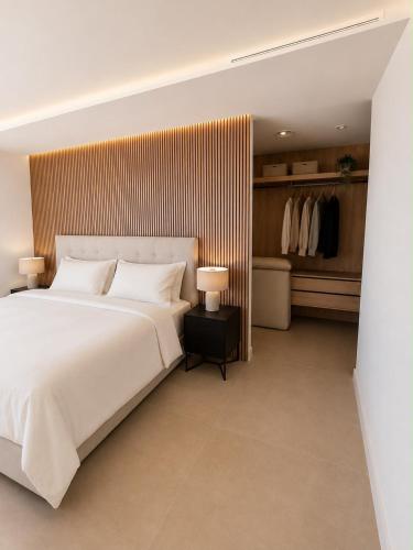 a bedroom with a large white bed and a closet at Our long Vacation in Quesada in Ciudad Quesada