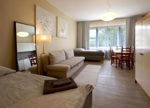 a living room with a bed and a couch at Libušina Villa in Kutná Hora
