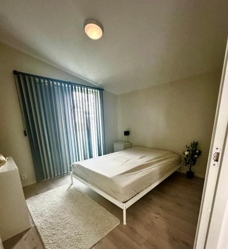 a bedroom with a bed and a large window at Three bedrooms house in Holmestrand