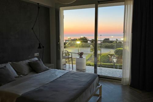 a bedroom with a bed and a view of the ocean at Haddar Etna in Zafferana Etnea