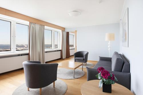 a living room with a couch and chairs and windows at Original Sokos Hotel Viru in Tallinn