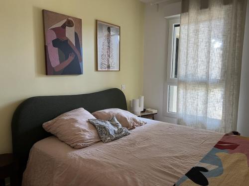 a bedroom with a bed with two pillows on it at Cozy apartment in Moliets-et-Maa