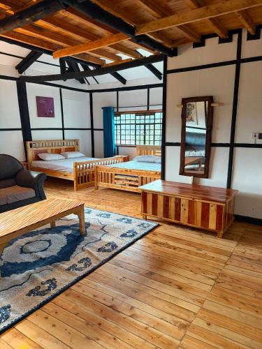 a room with two beds and a mirror at EarthShip Log Cabin, Timau in Nanyuki