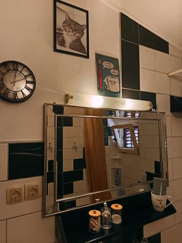 a mirror in a bathroom with a cat on the wall at Apartment SEA VIEW in Jelsa