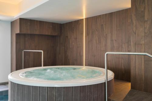 a jacuzzi tub in a bathroom with wooden walls at VILLA BRANDA - Tavira Nature Hotel in Tavira