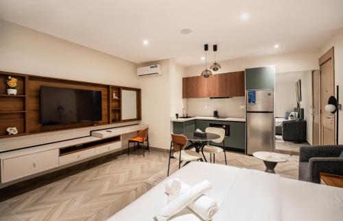 a kitchen and a living room with a large television at Zee Residence in Lagos
