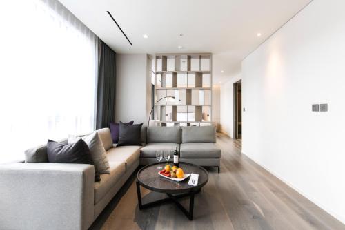 a living room with a couch and a table at Hotel Nanta Jeju in Jeju