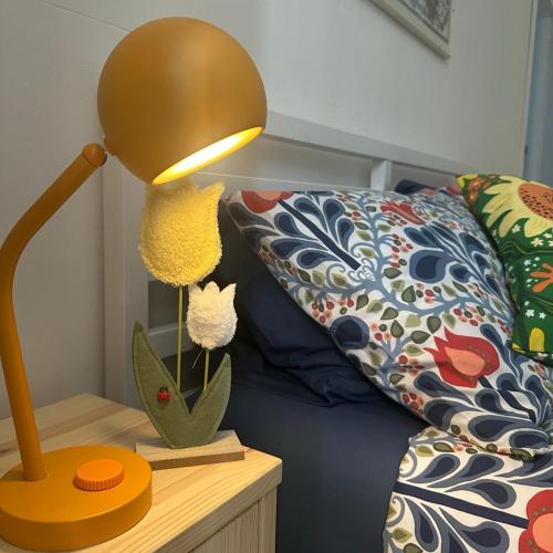 a lamp on a table next to a couch at Mare e Tulipani in Porto San Giorgio