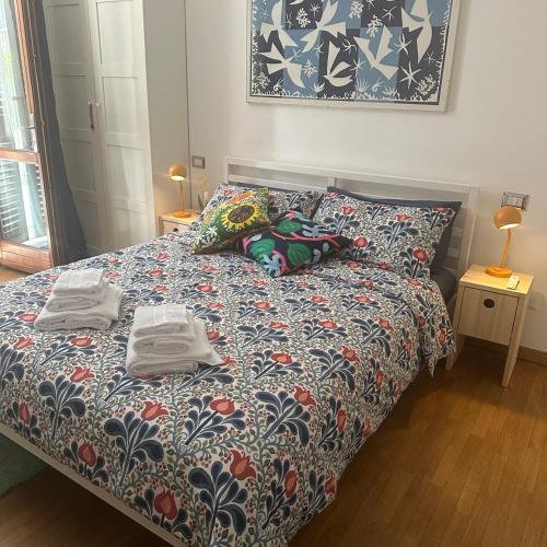 a bedroom with a bed with two towels on it at Mare e Tulipani in Porto San Giorgio