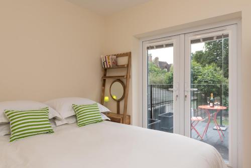 a bedroom with a bed and a sliding glass door at North Parade Avenue in Oxford