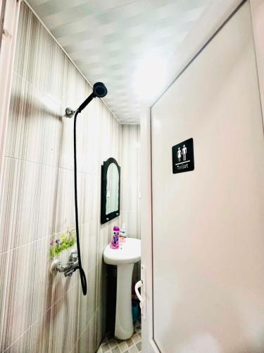 a bathroom with a sink and a mirror and a shower at Budget Home in Kutaisi