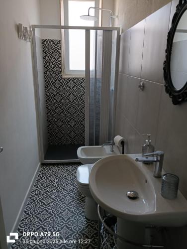 a bathroom with a sink and a toilet and a shower at Borghetto sant'irene in Erchie