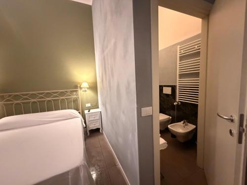 a bathroom with a bed and a toilet and a sink at Boutique Hotel Washington Milano - JCUBE HOTELLERIE in Milan