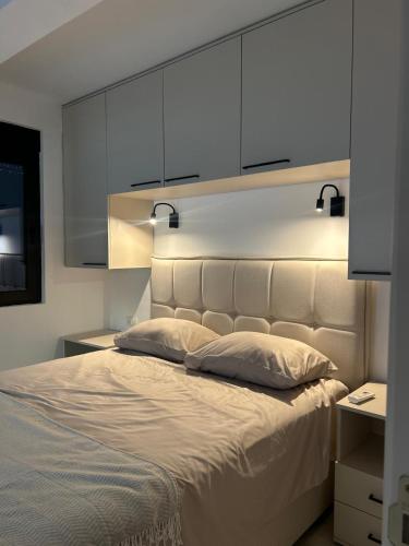a bedroom with a large bed with a large headboard at L 32 Sea view in Lepetani
